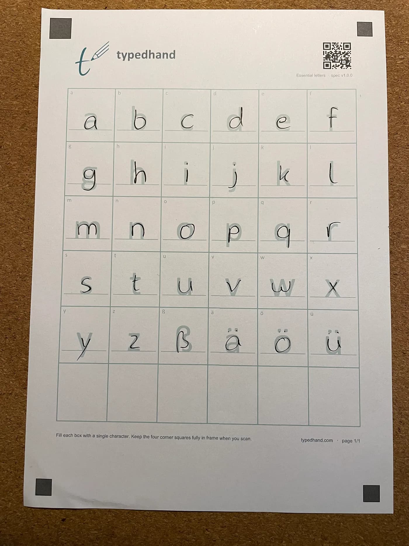 The same template filled in by hand with an ordinary pen, one letter per box.